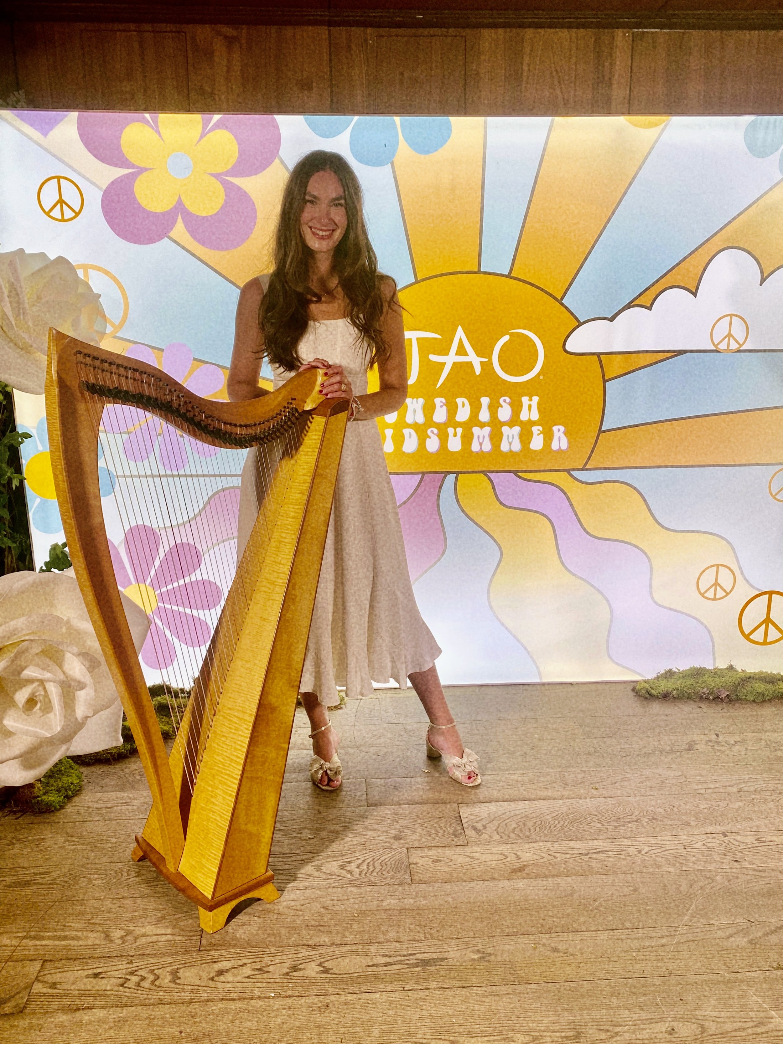 Mary Kate Boylan performs harp music for an event at Tao, in New York City