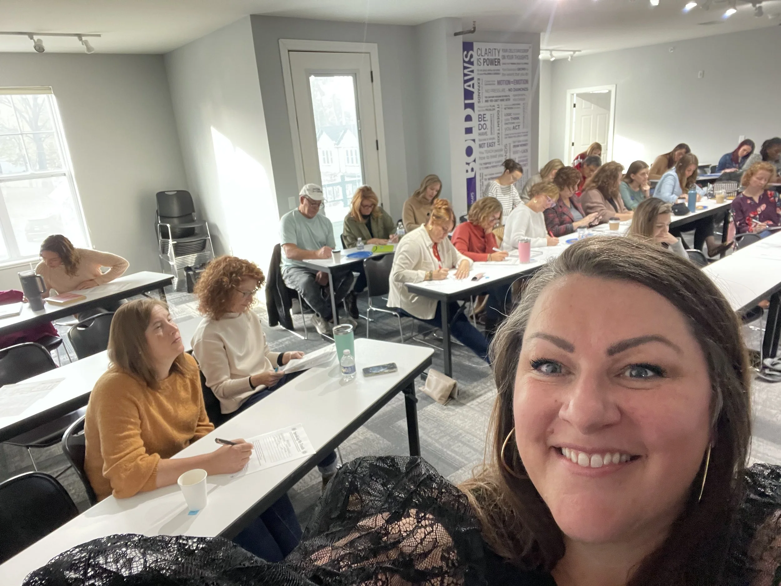 coach christine speaking selfie with room full of women