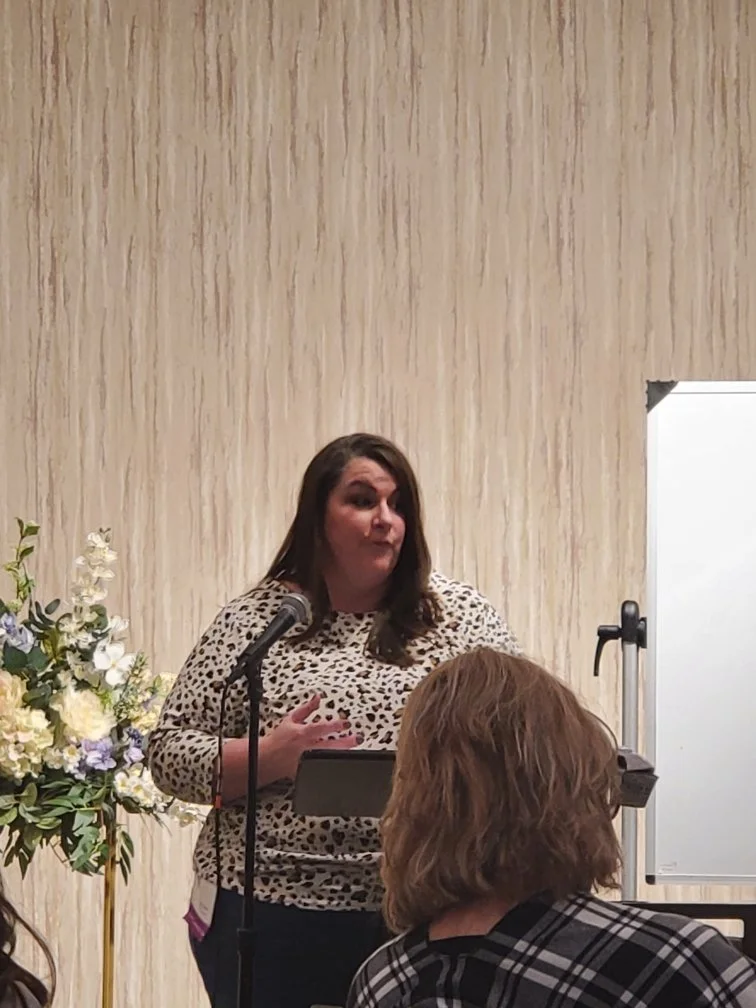 coach christine speaking into microphone