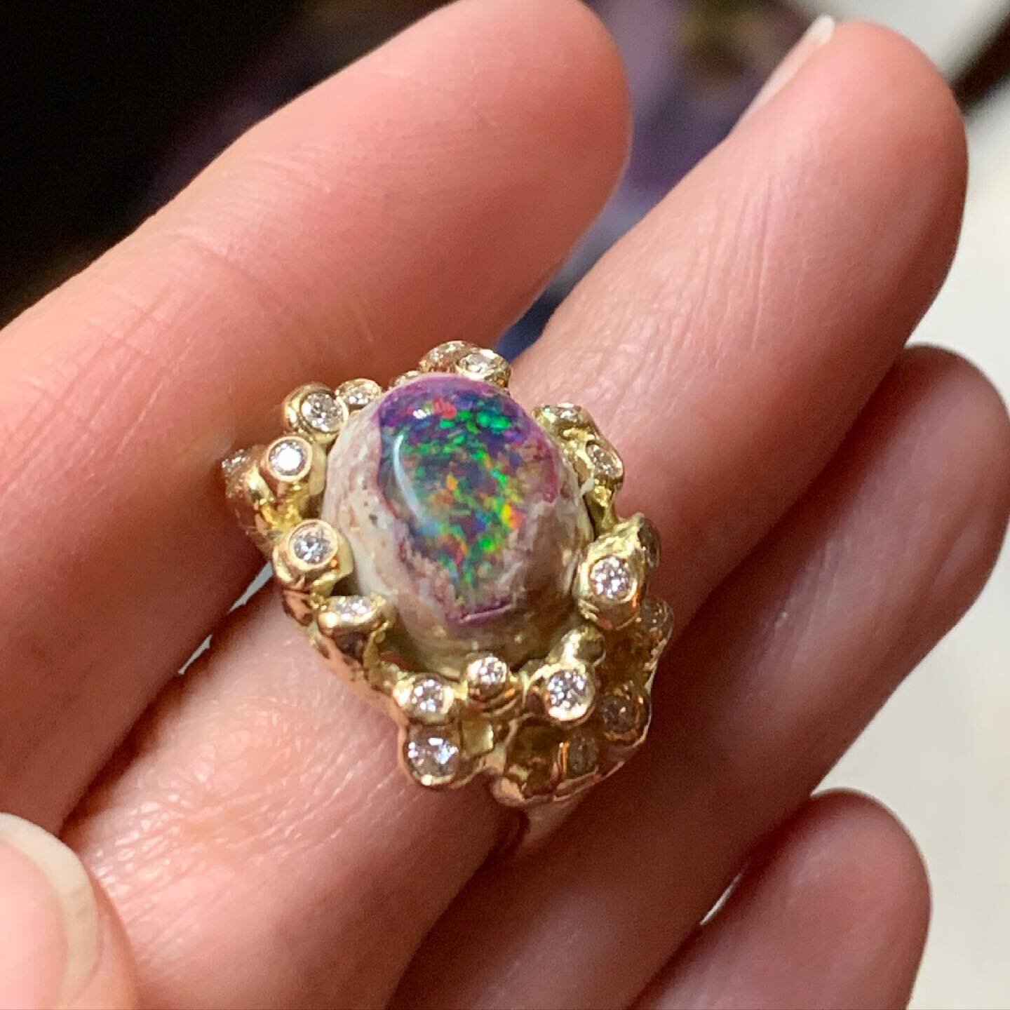 An extraordinary Mexican matrix opal that holds a small universe, like a colorful vortex swirling, in the center of a sparkling diamond sky.