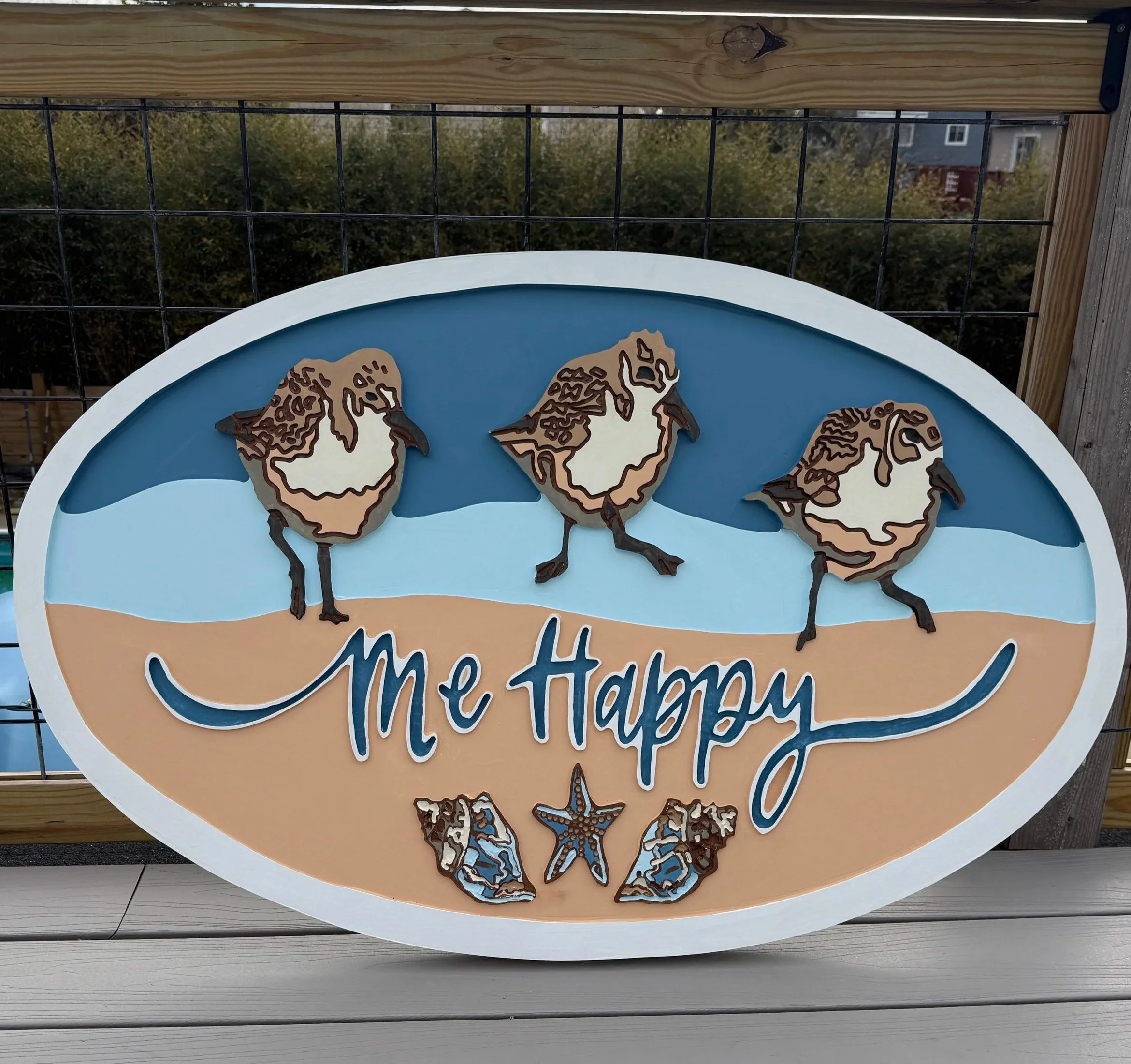 Decorative sign featuring a world map with animal illustrations, mounted on a wooden frame with a metal grid background.