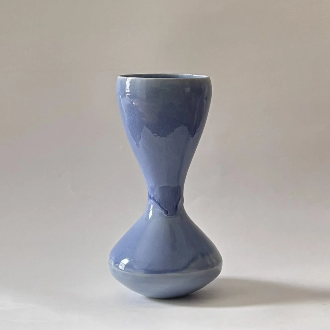 glossy blue hourglass vase