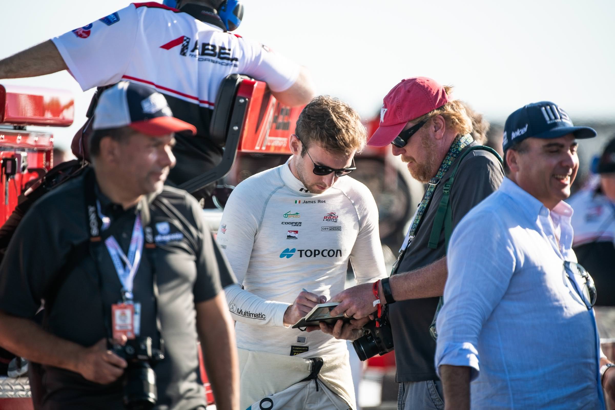 Topcon's driver, James Roe signs an autograph