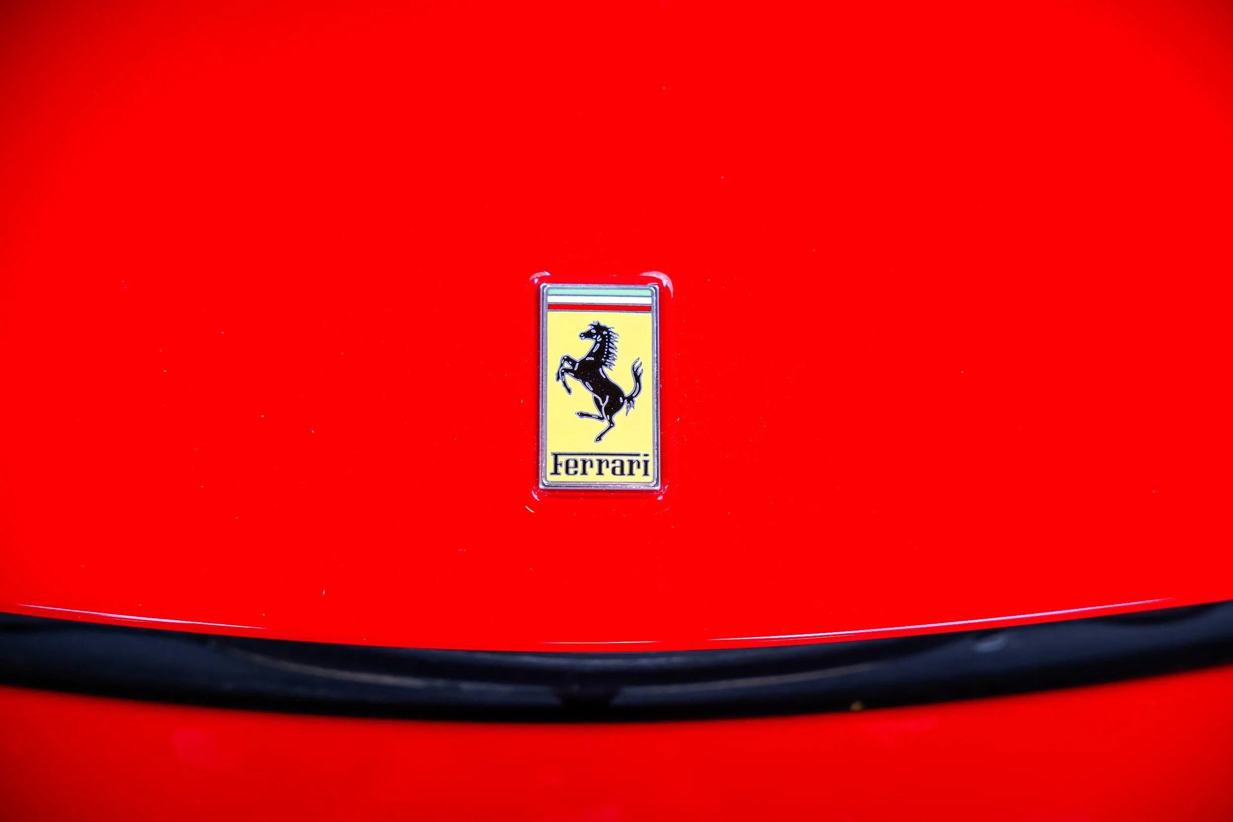 Close-up of a red Ferrari with the Ferrari logo in the center.