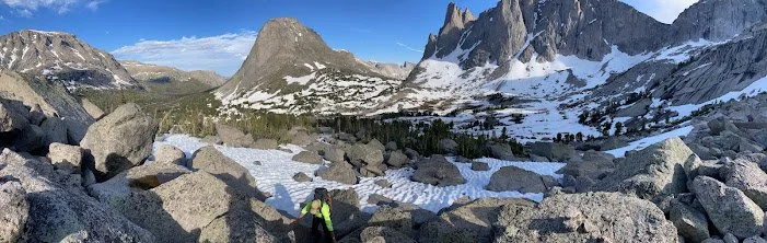 A rescuer scrambling over broken rock in the Cirque of the Towers