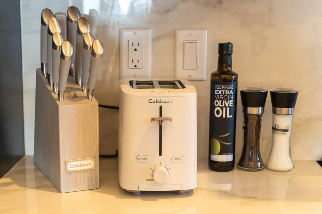 Knife block, toaster, olive oil, salt, and pepper on kitchen counter in the Downtown Luxury Condo at Hotel Thaxter in Portsmouth, New Hampshire.