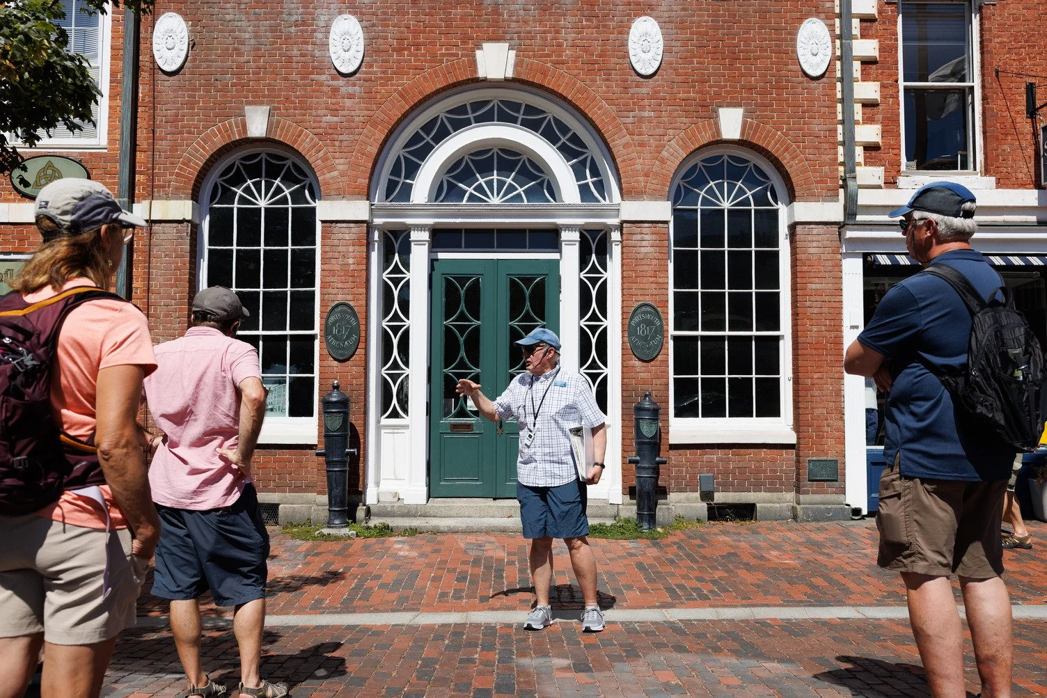 Visitors participate in a guided historical walking tour through downtown Portsmouth, New Hampshire during America's 250th anniversary celebrations.