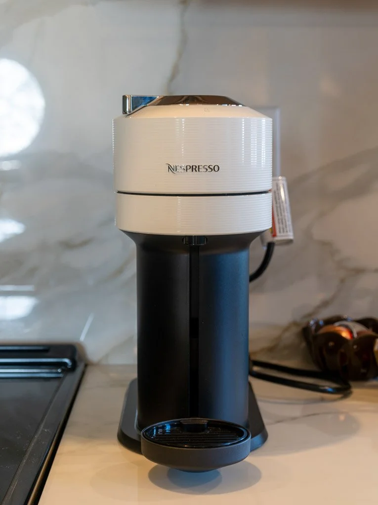 Nespresso machine on marble backsplash in the Downtown Luxury Condo at Hotel Thaxter in Portsmouth, New Hampshire.