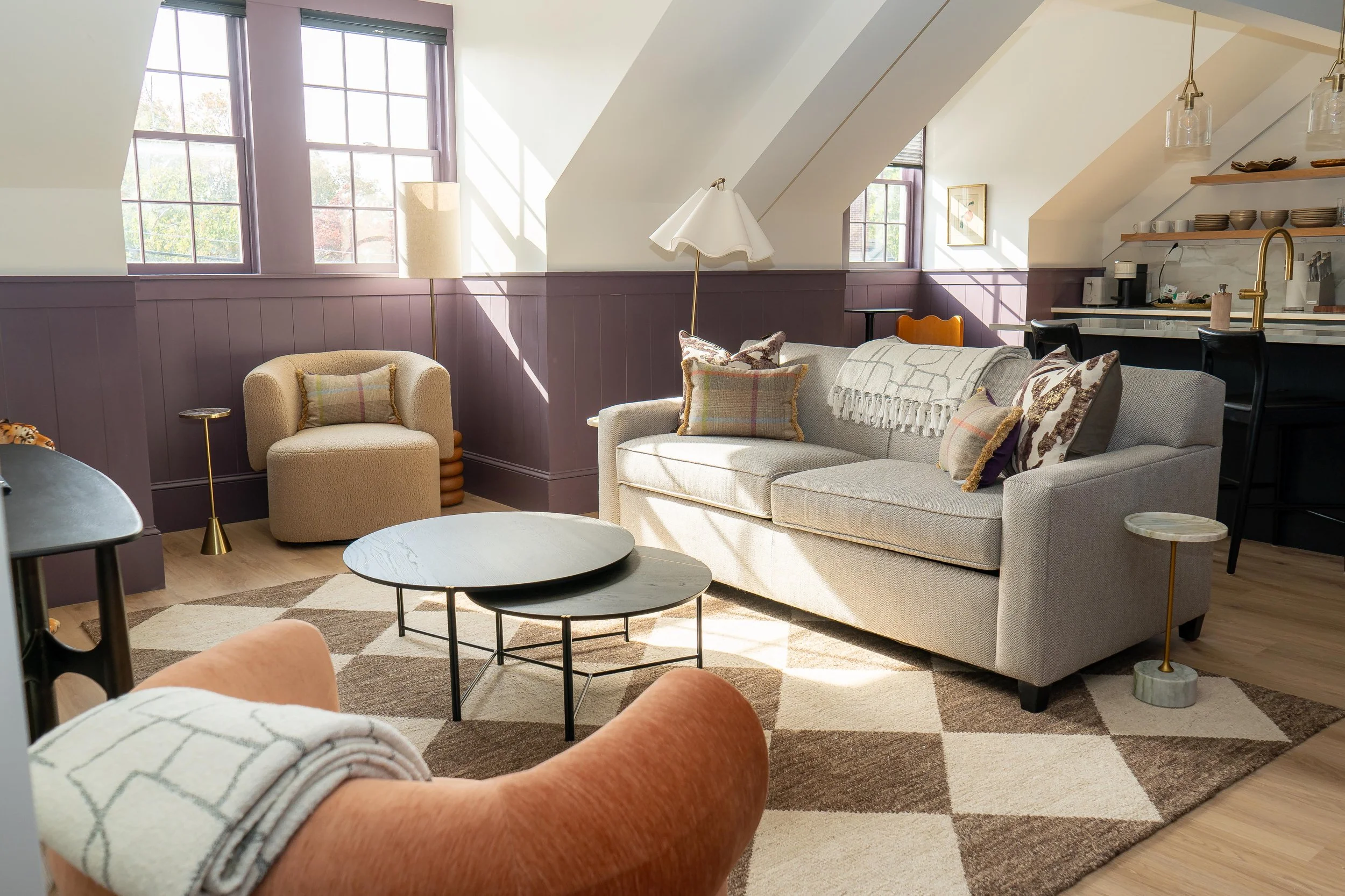 Sunlit suite at Hotel Thaxter featuring a spacious living area, vaulted ceilings, and comfortable seating in downtown Portsmouth, New Hampshire.