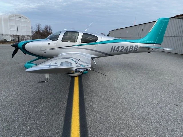 Small single-engine airplane parked on tarmac