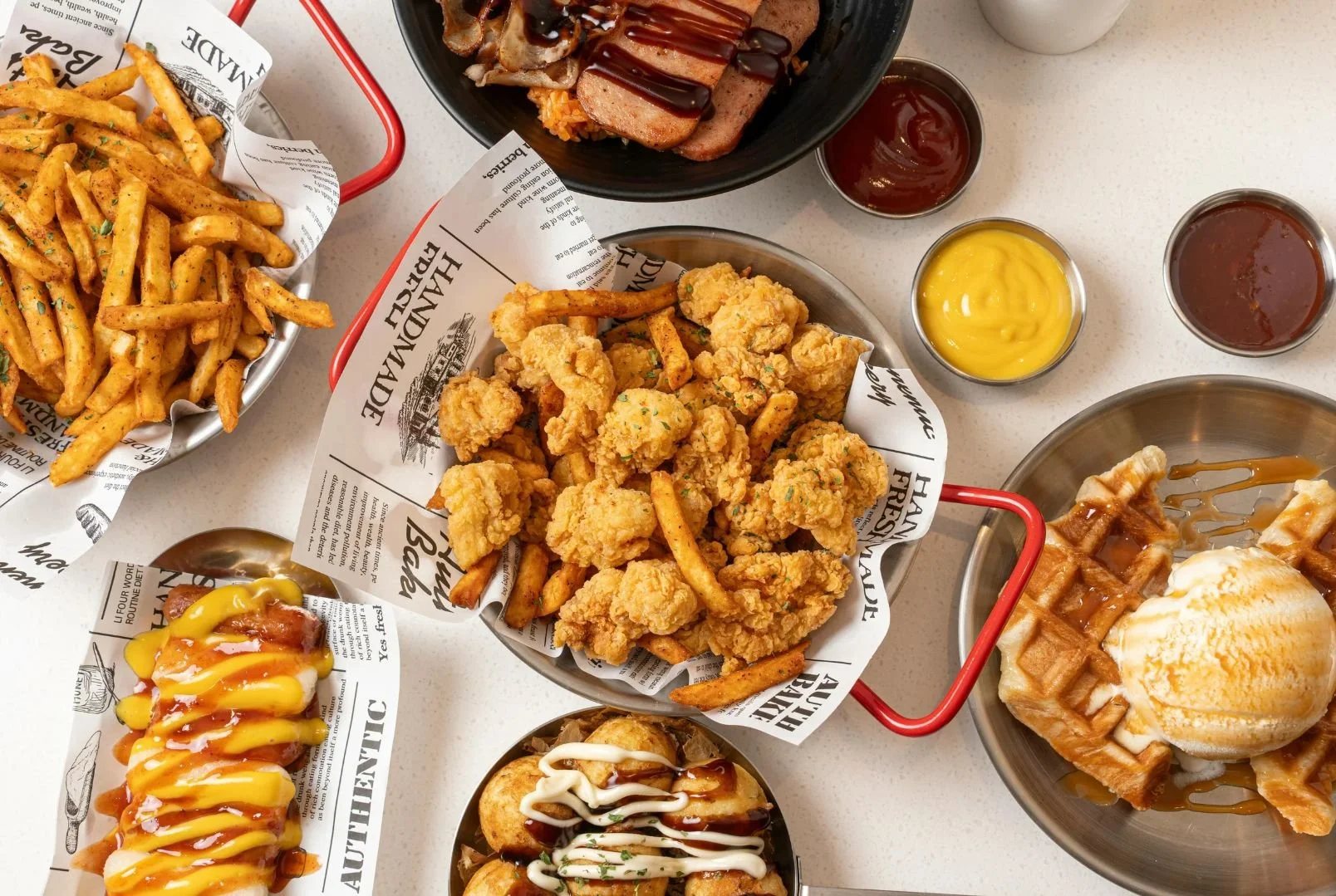 top view of fried foods & sweets - fries, spam, takoyaki, chicken