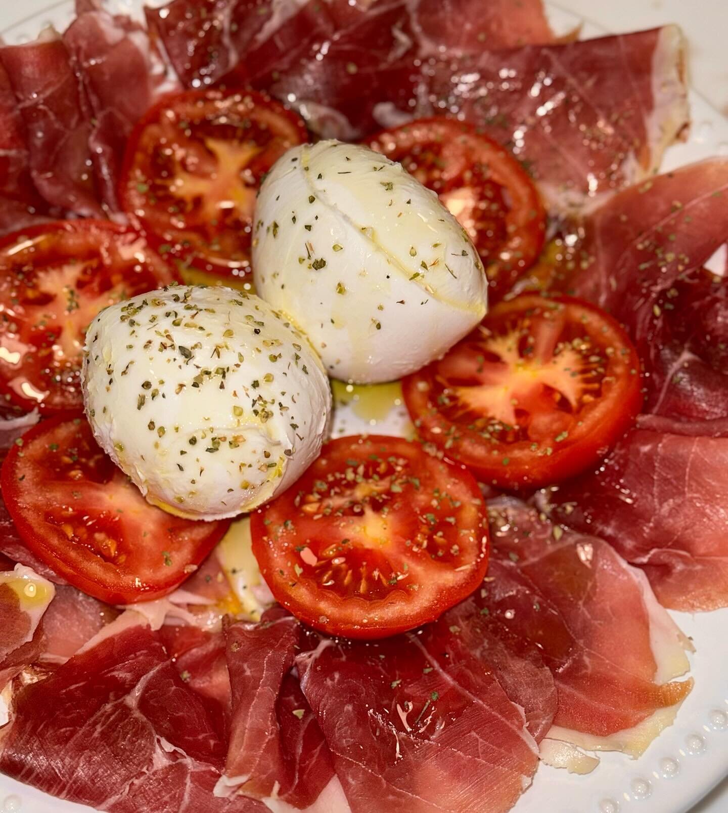 Fresh Bufala mozzarella over tomato salad and prosciutto San Daniele. #freshbufalamozzarella #italianafoods #cateringservice #privateevents #bufalasalad