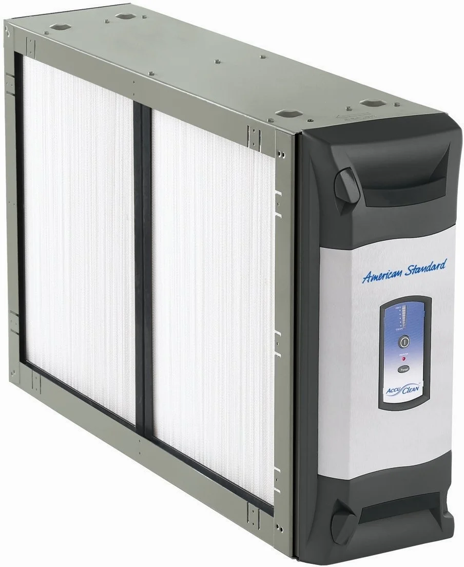 An air purifier with a rectangular body, labeled American Standard, featuring a control panel with a dial and indicator lights on the front.