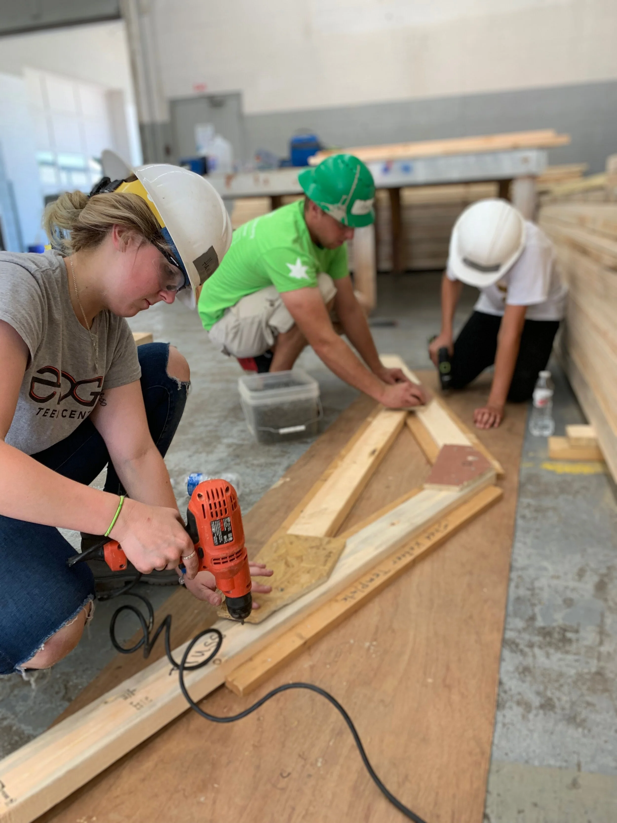 Photo of Hannah Cook using a drill at Habit for Humanity