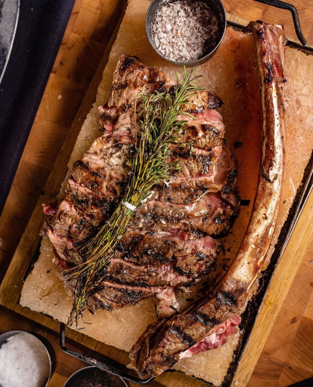 A signature dLe&ntilde;a experience featuring a mezcal-flamb&eacute;ed Tomahawk finished tableside with bone marrow butter and served with your choice of two sides. 

Bold, smoky, and designed for a memorable shared dining moment.