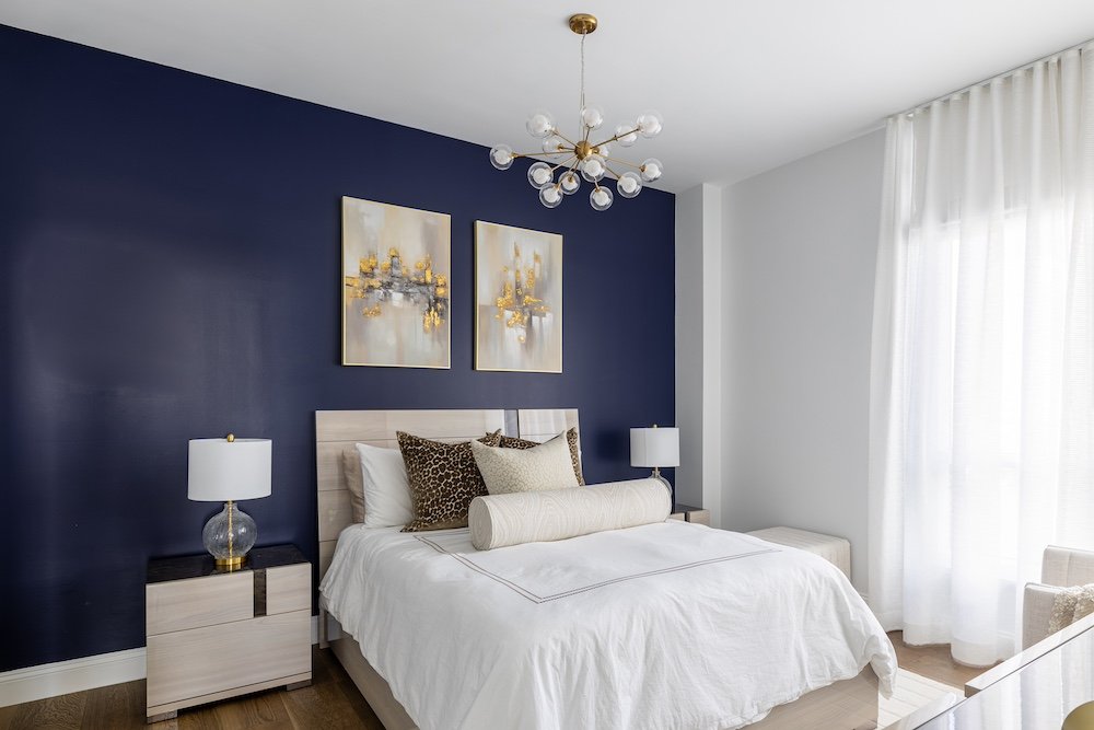 navy-accent-wall-artwork-bedroom-white-curtains.jpg