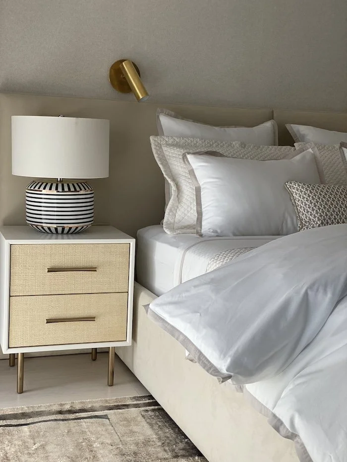 nightstand-lamp-sconces-pillows-kingsize-bed.jpg