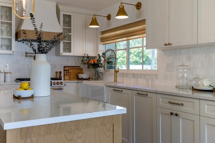 kitchen-lights-white-countertops-window-sink.jpg
