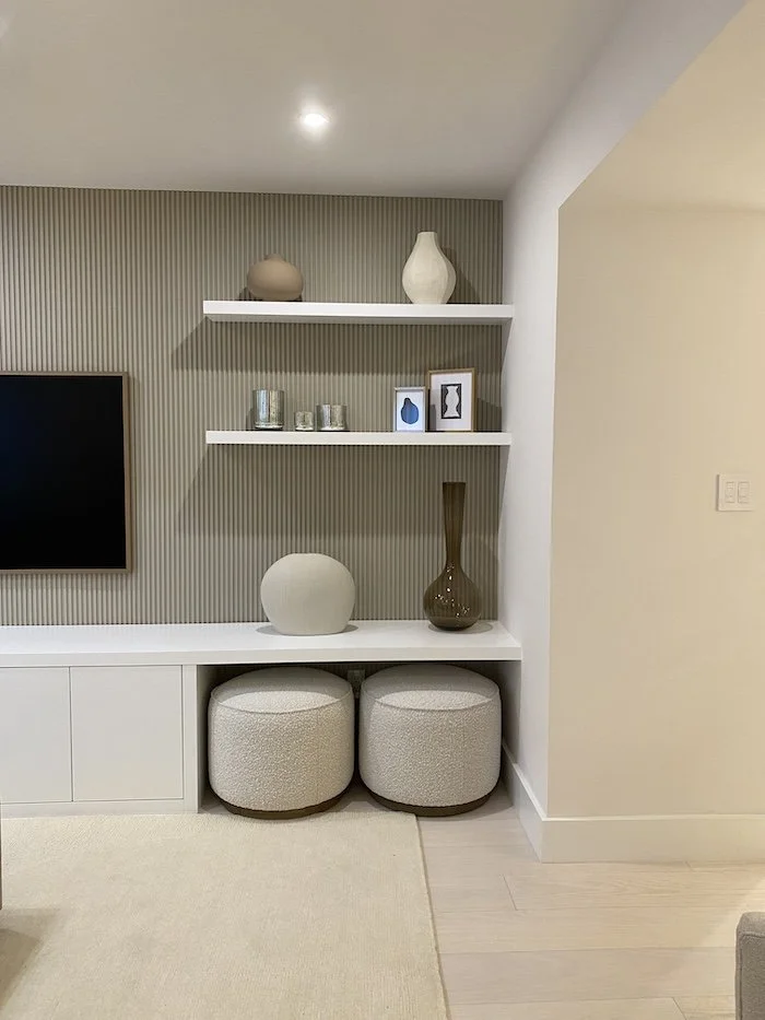 two-small-neutral-beige-ottomons-bookshelves.jpg
