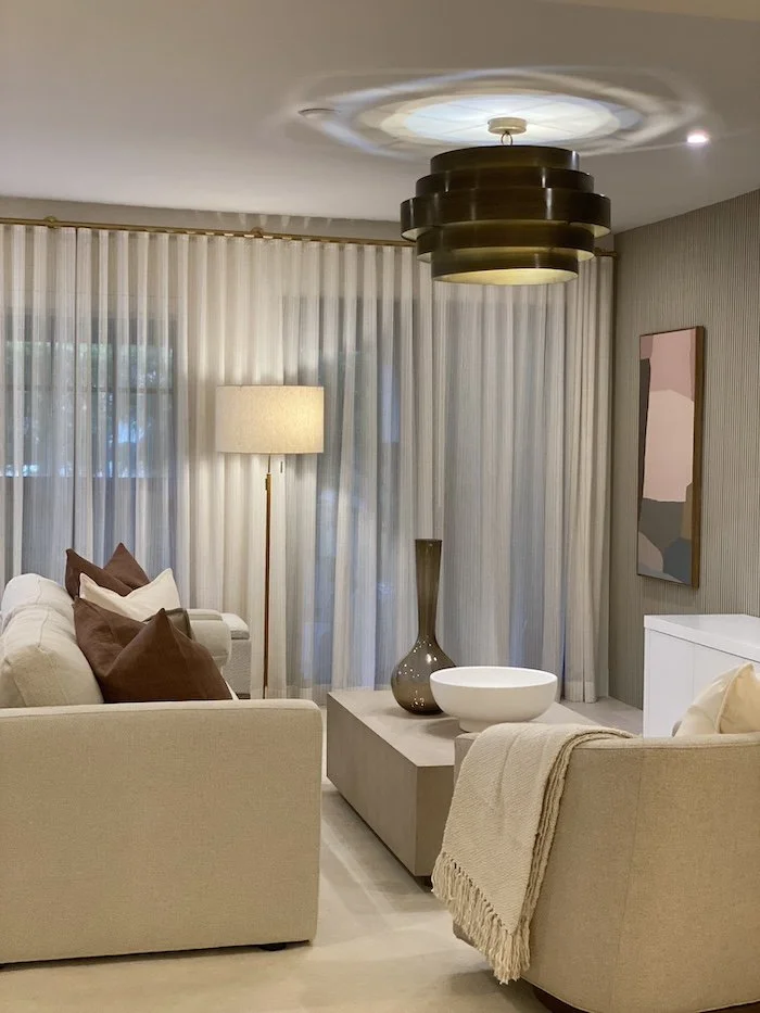 bronze-light-fixture-beige-couch-neutral-livingroom.jpg