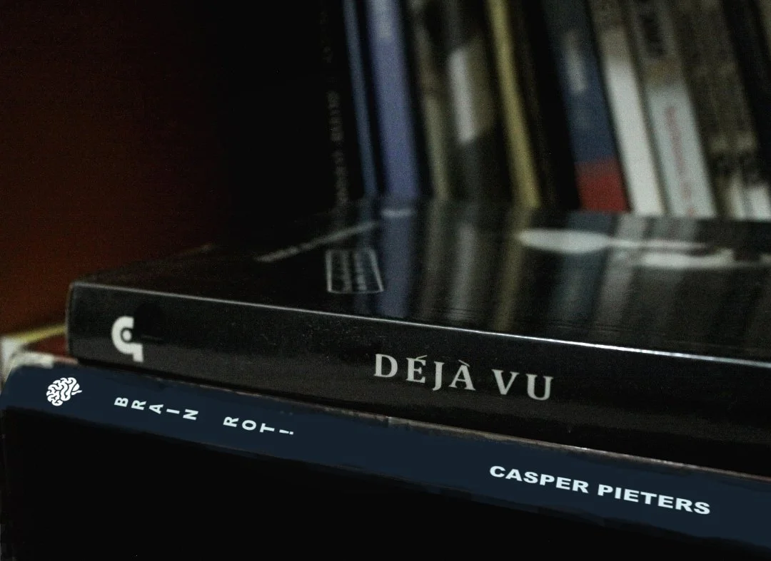 A vague image of a stack of books with two books lying flat at the front.