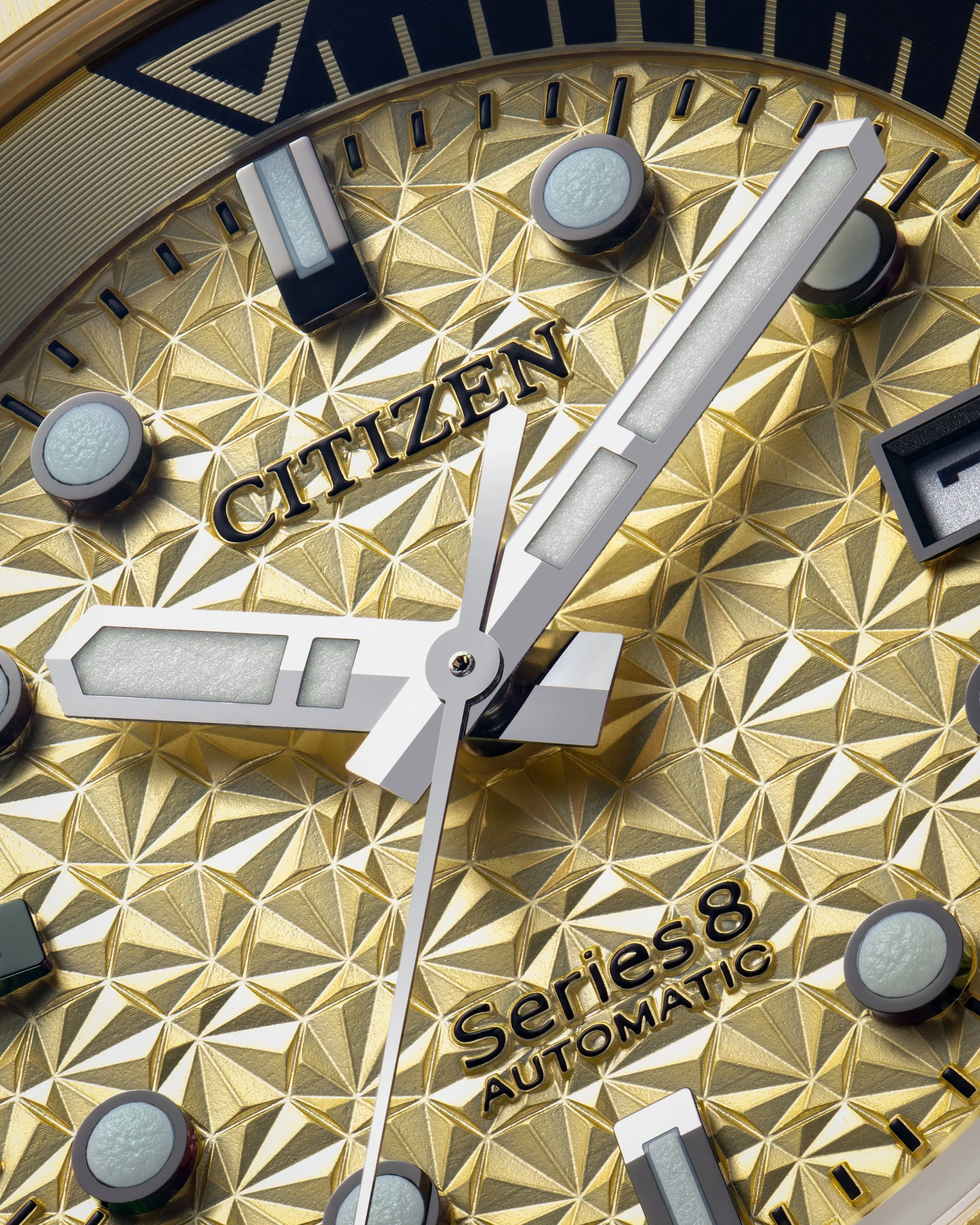 Close-up of a Citizen Series 8 Automatic wristwatch with a gold textured dial, silver hour and minute hands, and white luminous hour markers.