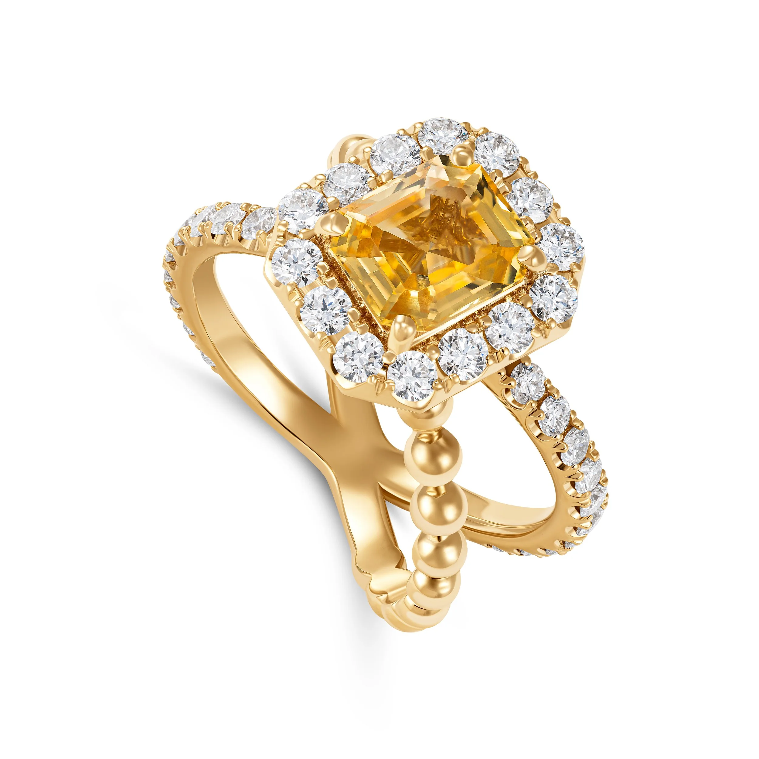 Gold ring with a large central yellow gemstone surrounded by smaller clear diamonds, featuring a beaded band and a decorative split shank design.