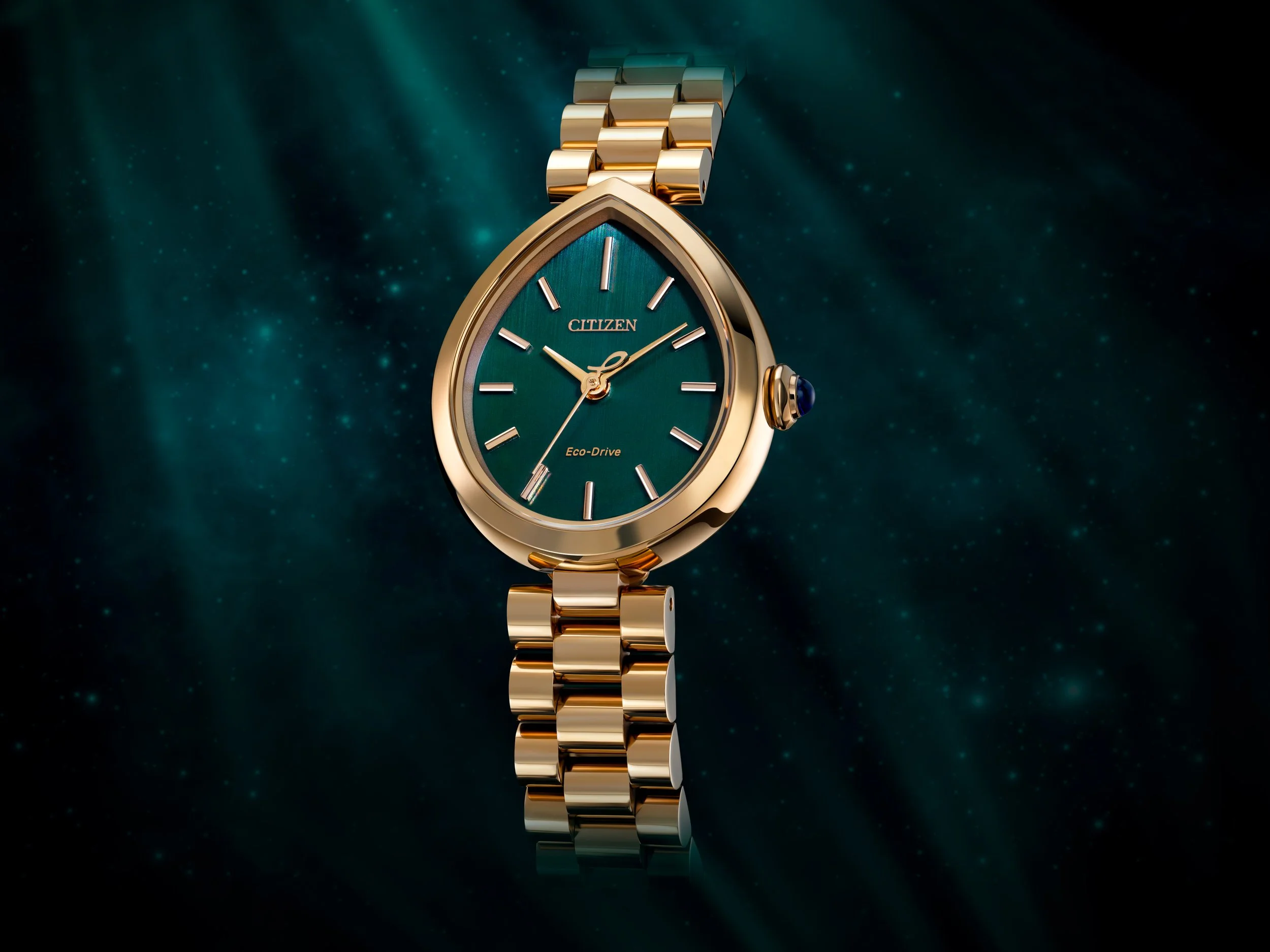 Luxury Citizen Eco-Drive watch with a gold band and a green face against a starry dark background.