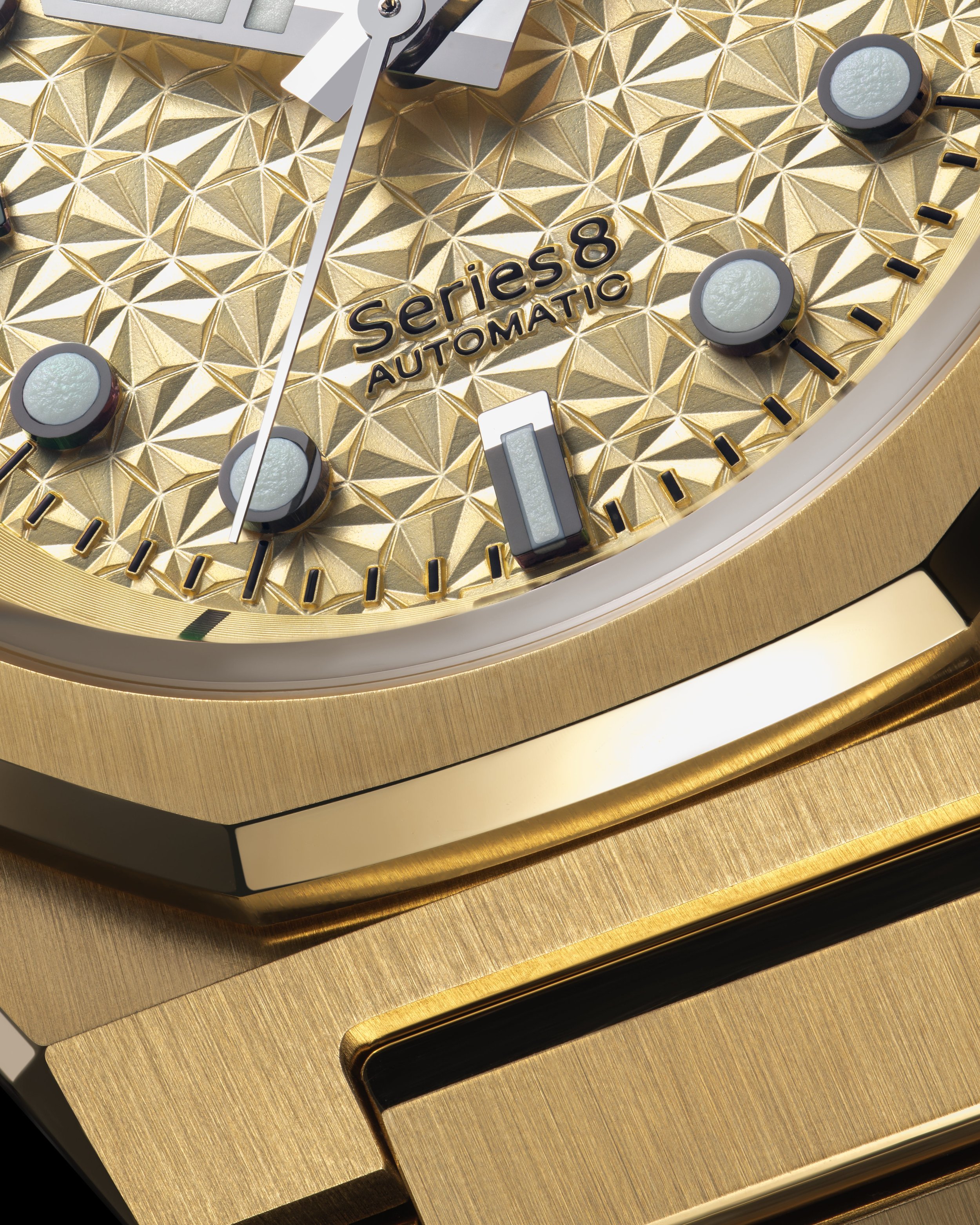 A close-up of a gold-colored wristwatch with a textured dial, featuring black markers, white luminescent hour markers, and the text 'Series 8 AUTOMATIC' on the face.