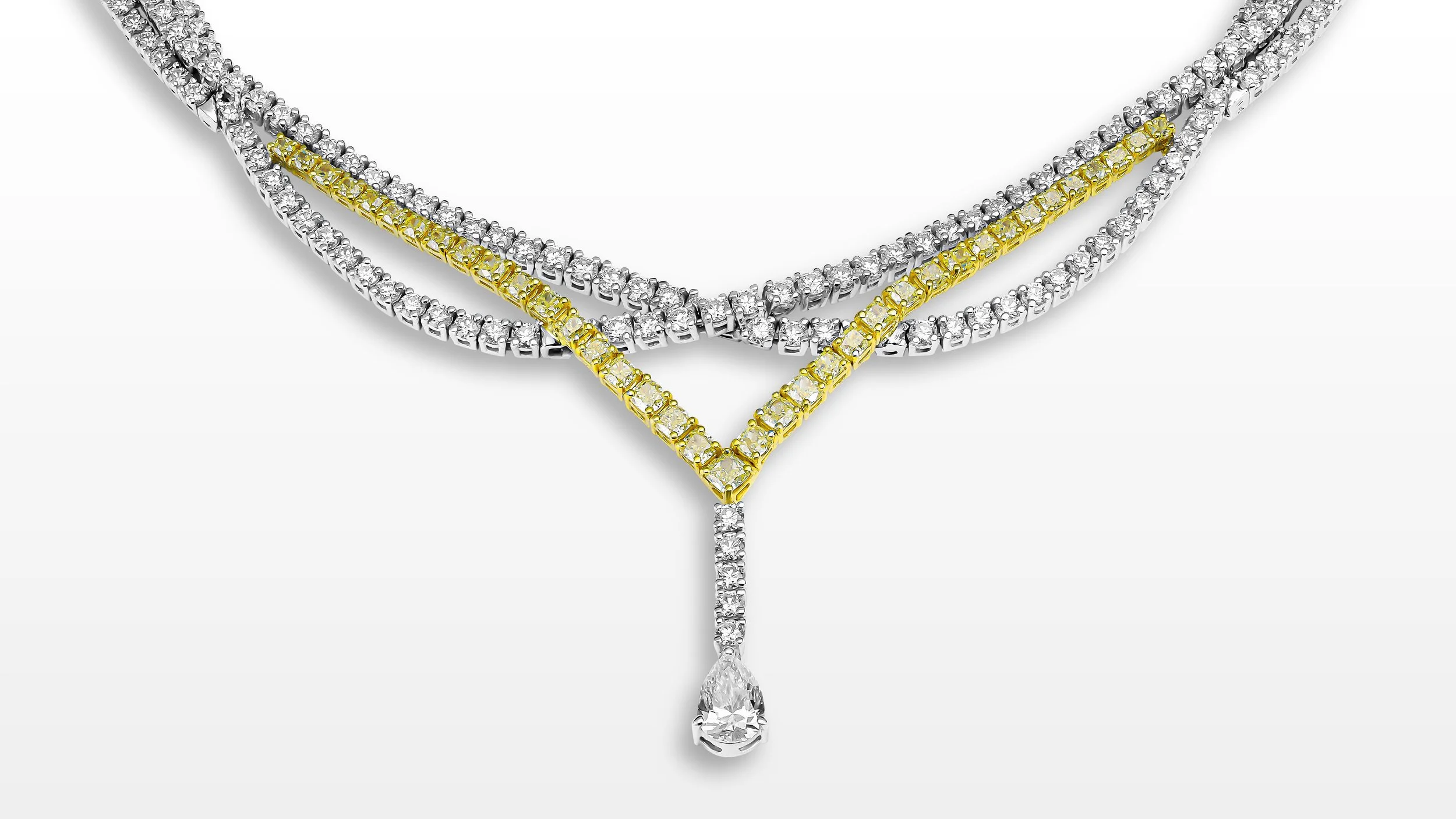 Three layered diamond necklaces, with one featuring yellow gold accents and a teardrop-shaped diamond pendant.