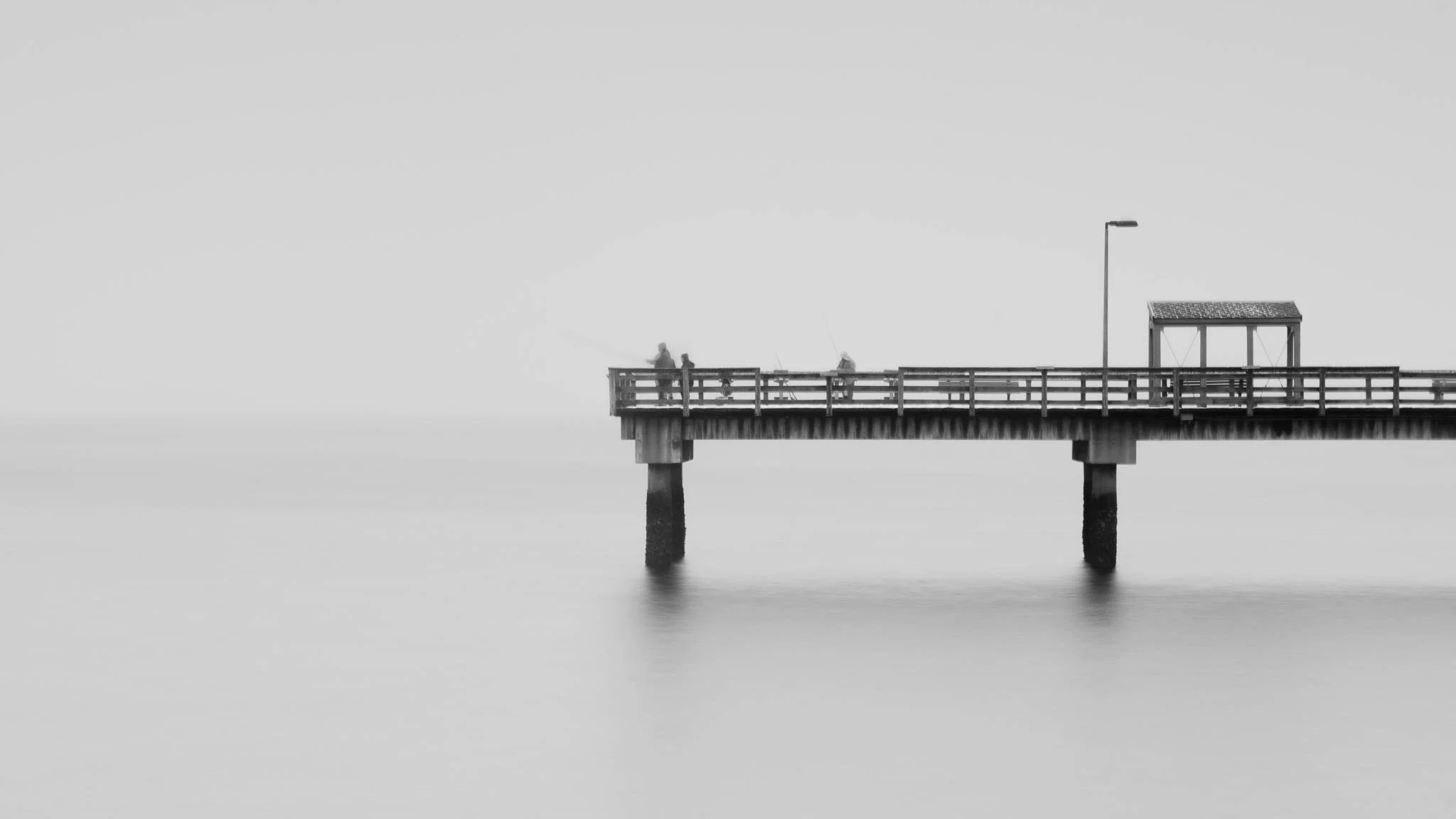 Stillness as structure. The wooden lines of the pier intersecting with an endless horizon.