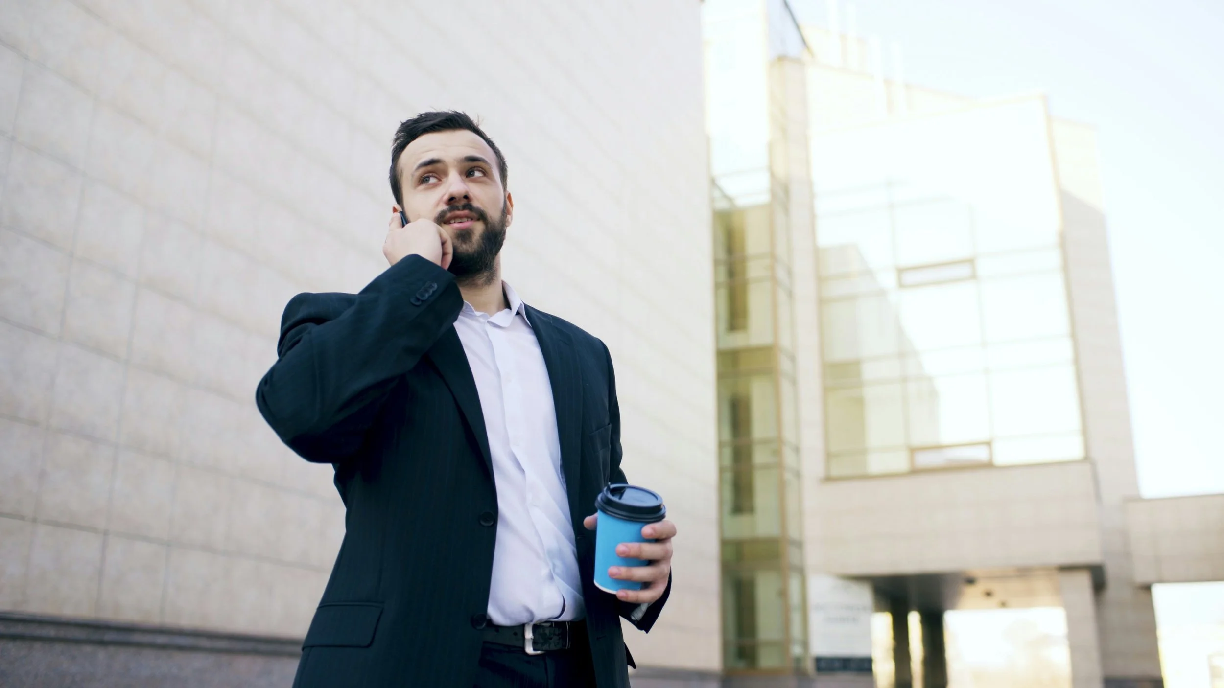 nasirbayan.com-young-businessman-on-phone-outside-office-building (3840x2160).jpg