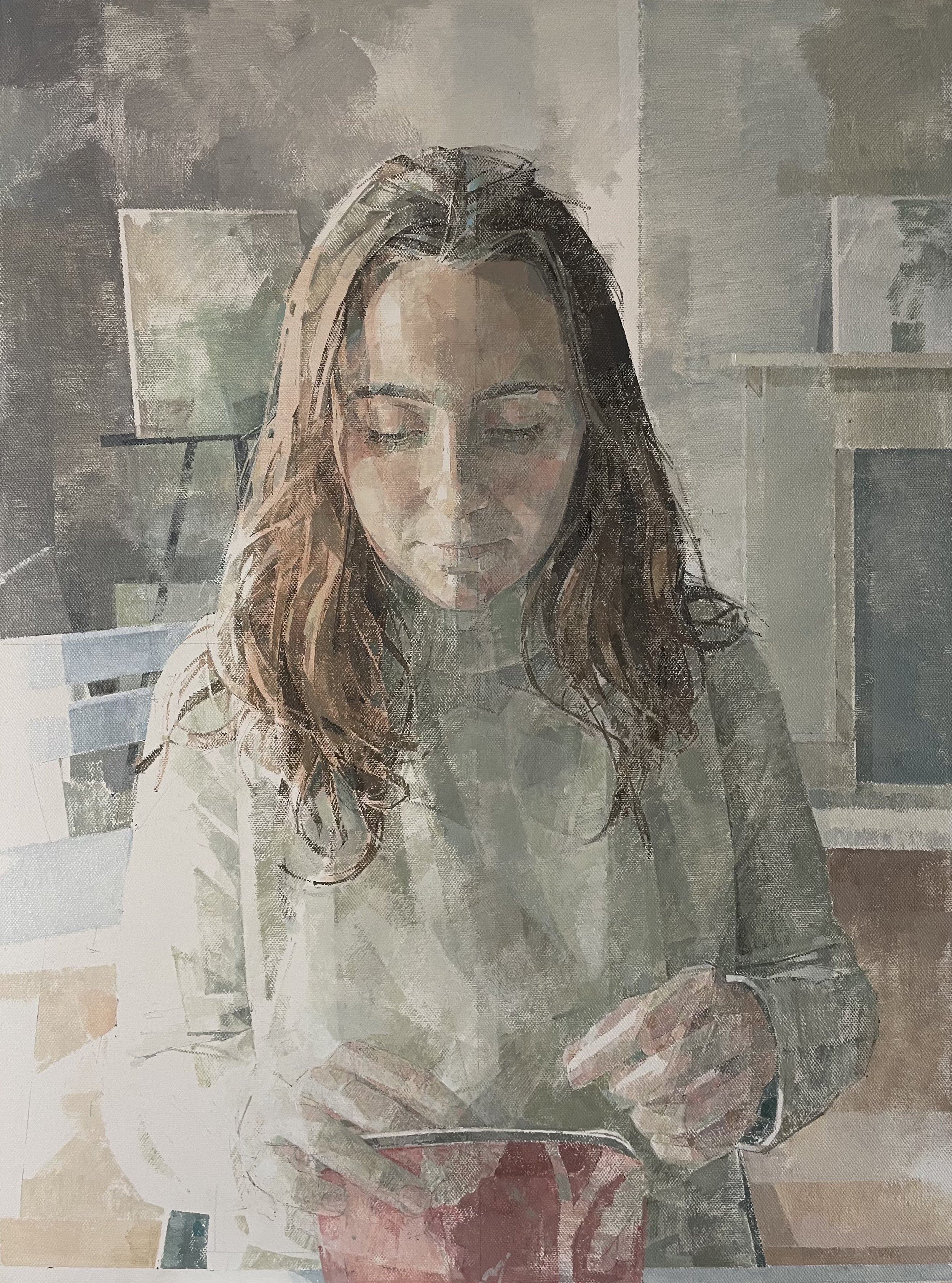 Portrait of a young woman with brown curly hair looking down at her bag