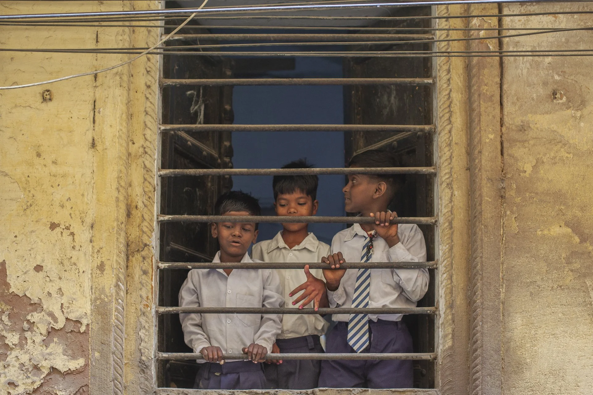 three school boys at the school window