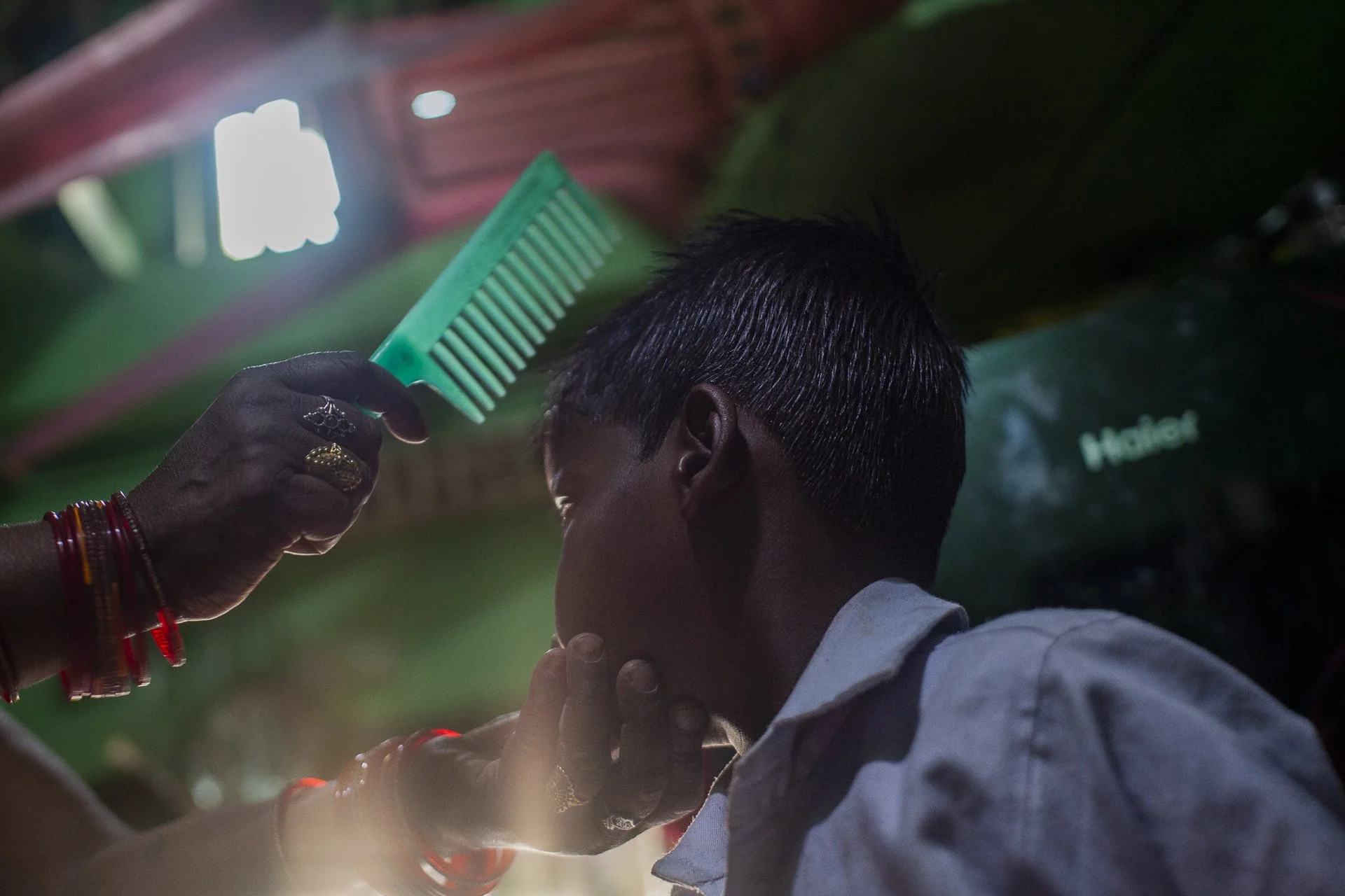 young boy having his hair combed before school