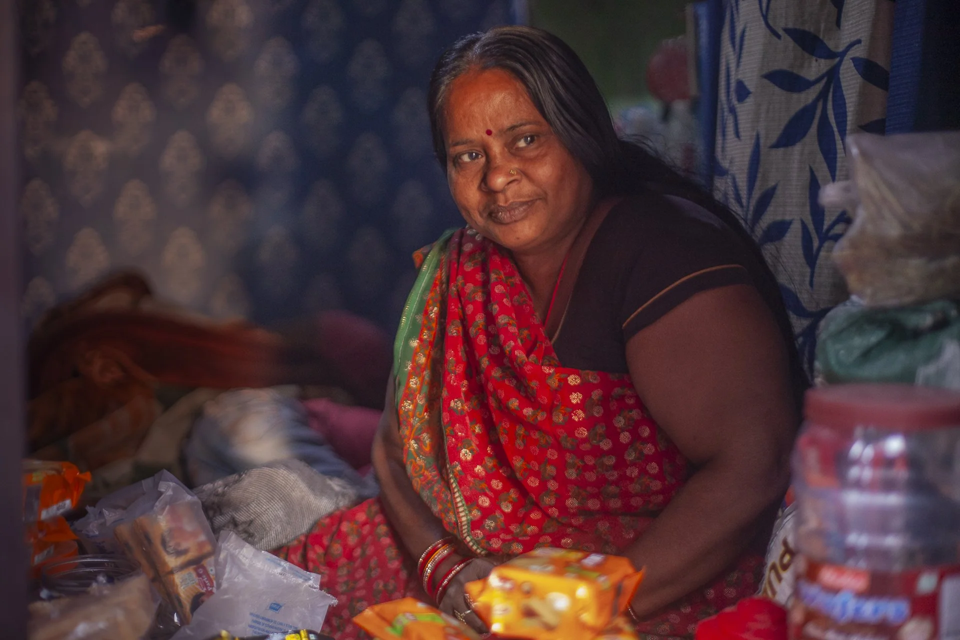 woman in sari looking out to morning light, Varanasi, India