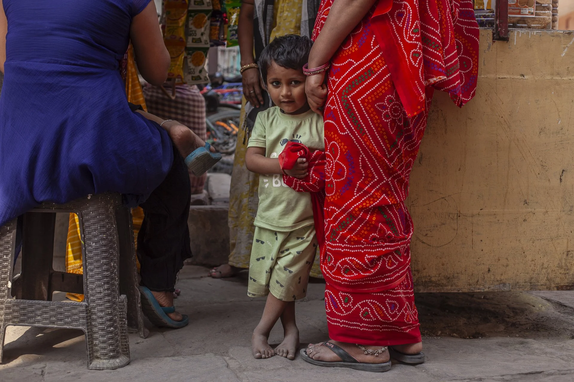 young boy with his mother in red sari