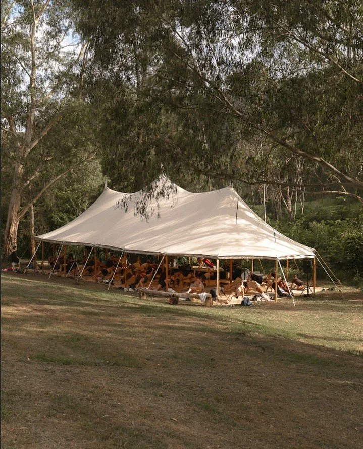 Under the beautiful tent by @matakata.event.hire is where we gather. ⁠
⁠
❤️ Morning image by @lucibphoto, of Strength Foundations workshop by @taylahjade.coaching at Ember Interlude, 2025.