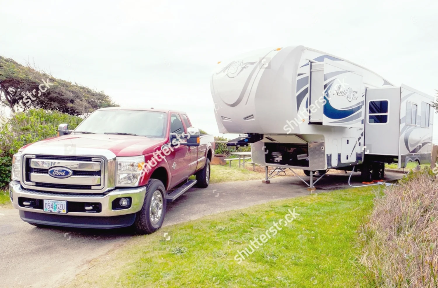 stock-photo-yachats-or-march-campsite-with-a-large-arctic-fox-th-wheel-and-a-ford-f-truck-394095835.jpg