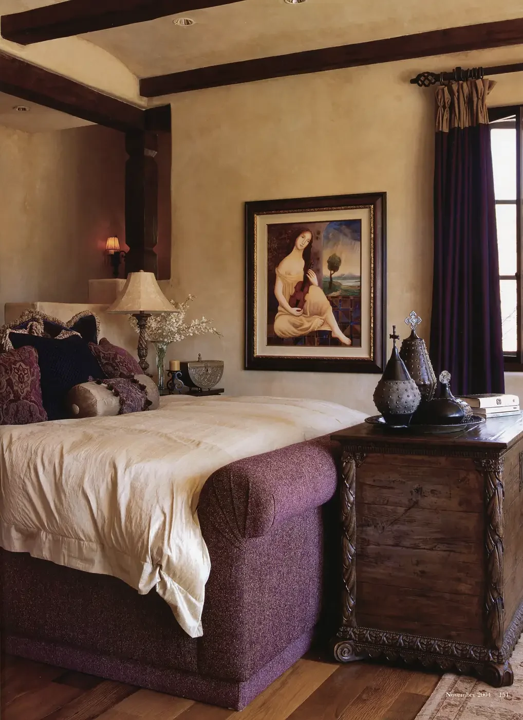  An upholstered bed in the master bedroom faces expansive views of the back yard and beyond. A painting by Elizbieta J. Osiak exudes a mood of reflection. 