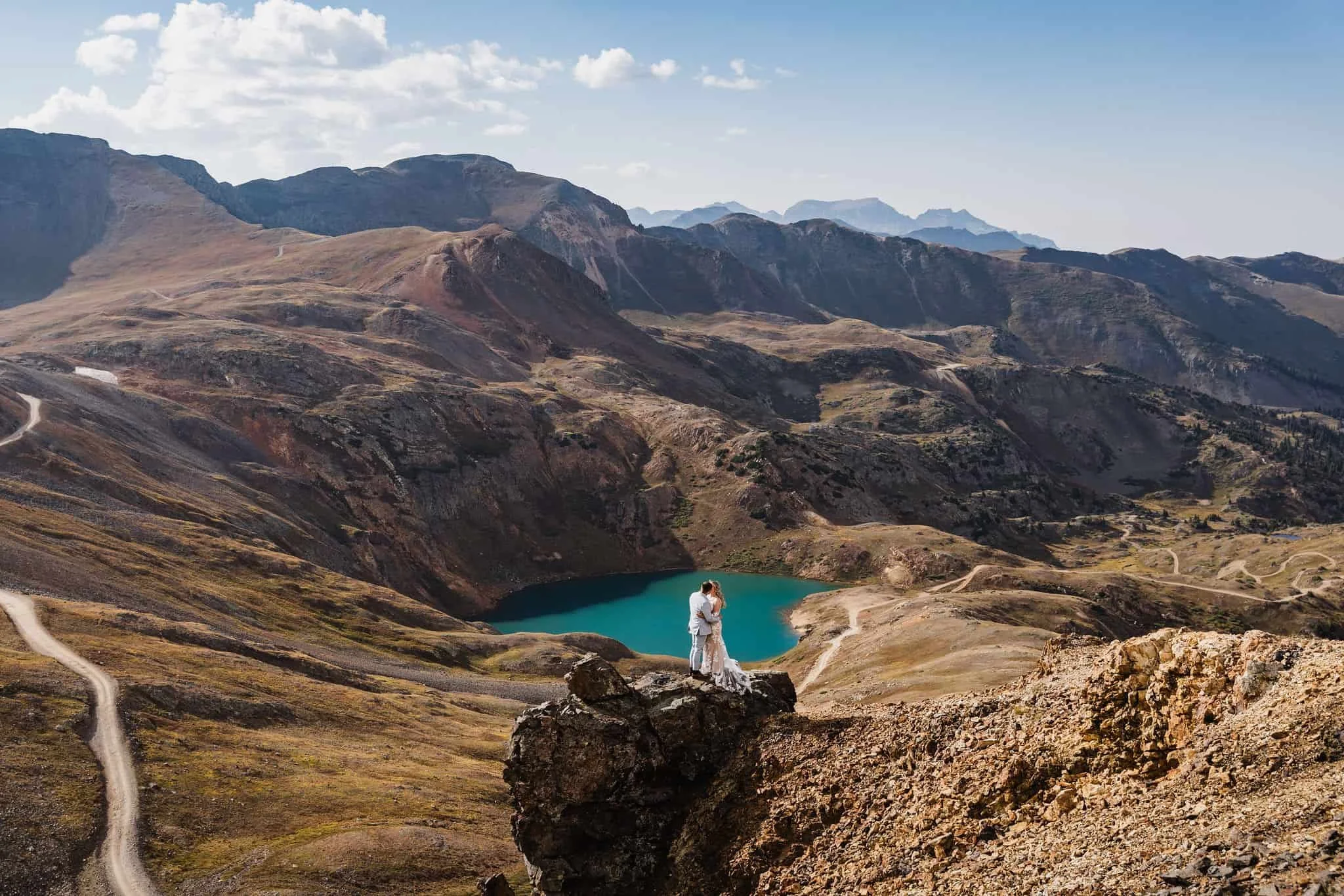 Mountain elopement above a blue lake