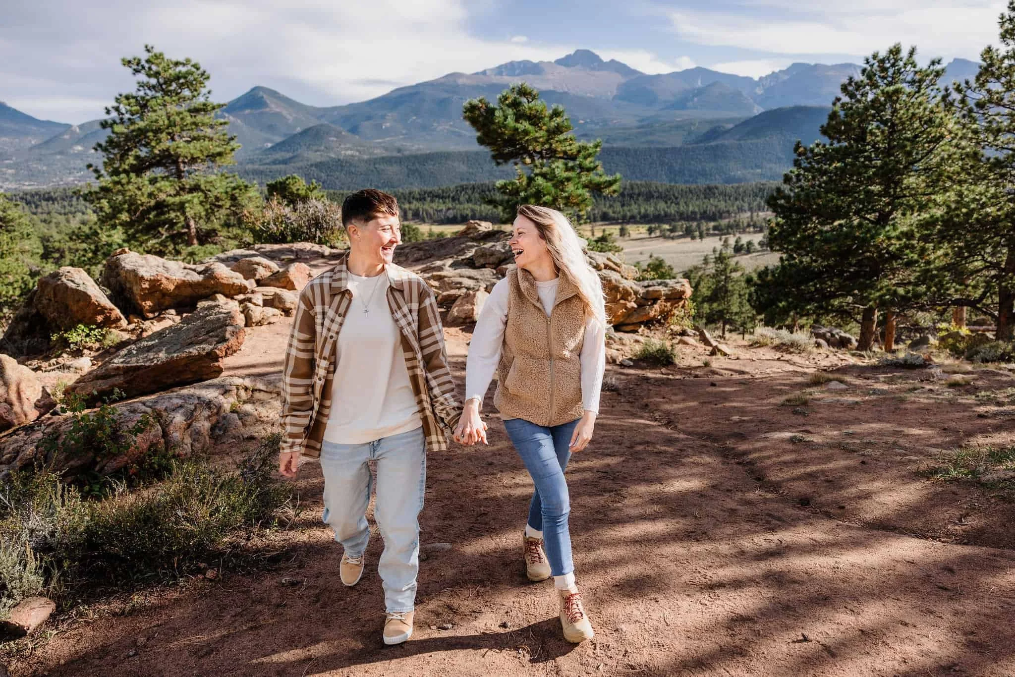 A couple walks down a mountain trail togther