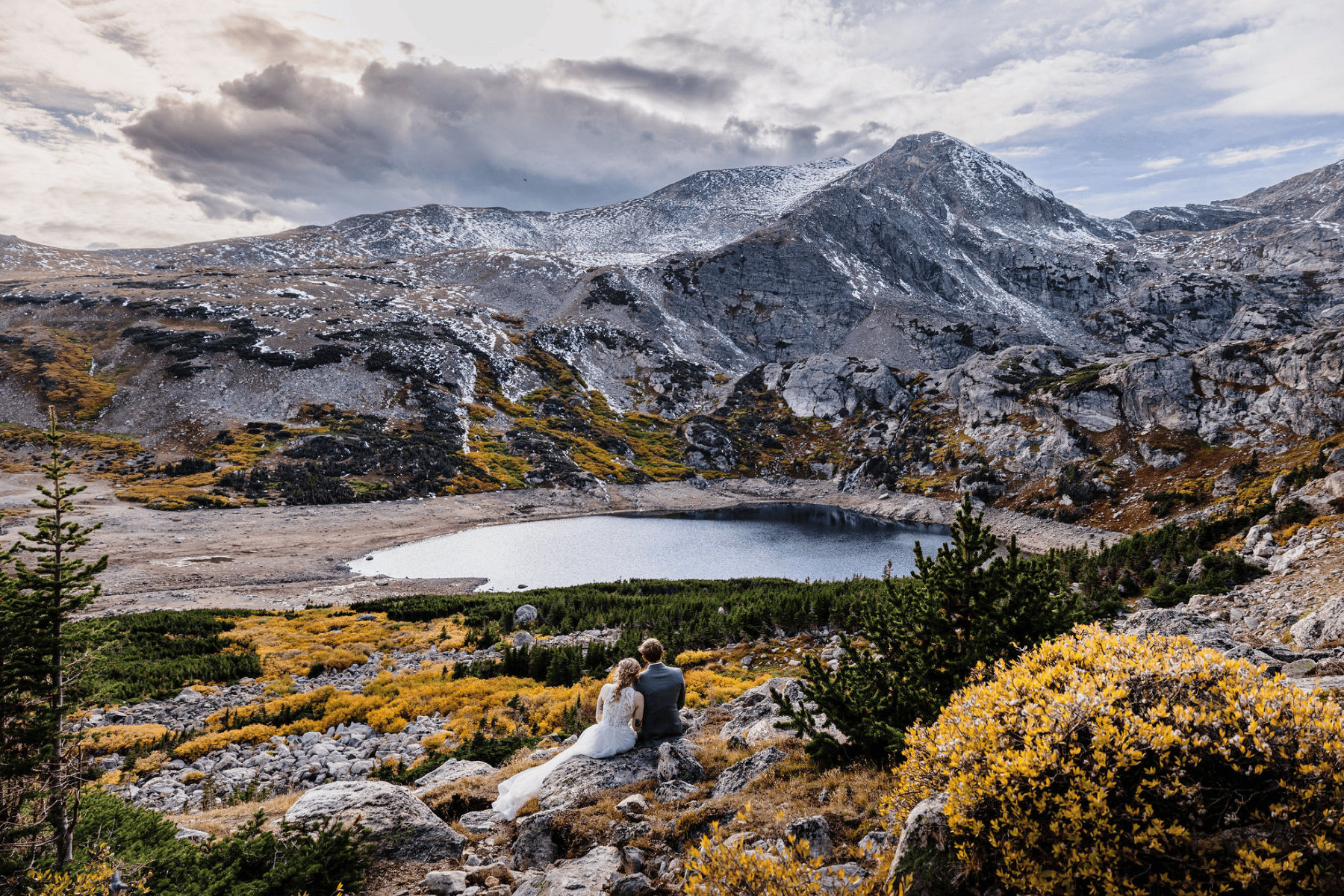 Elopement photo at an alpine lake with mountains