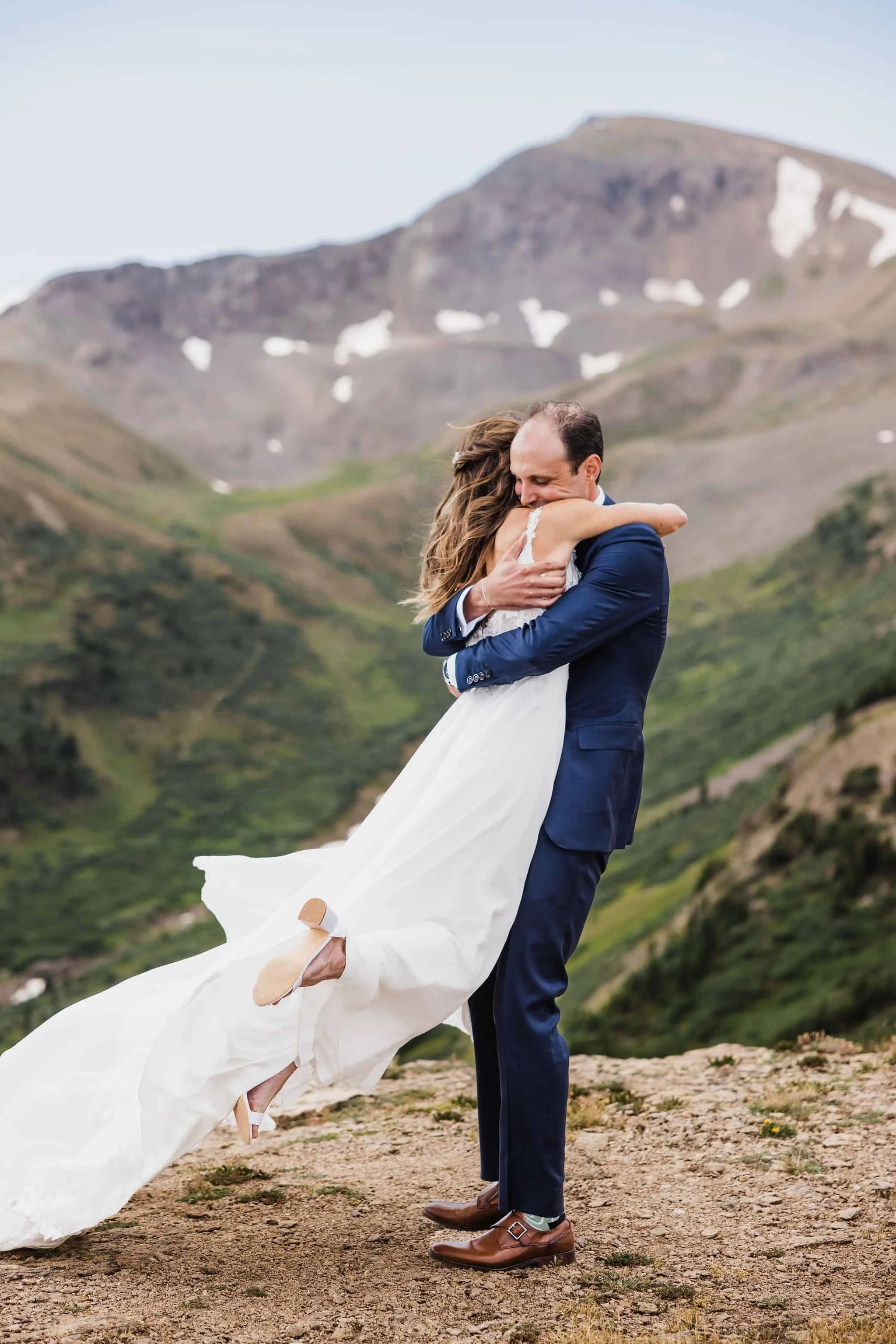 A couple hugs after their mountaintop elopement ceremony