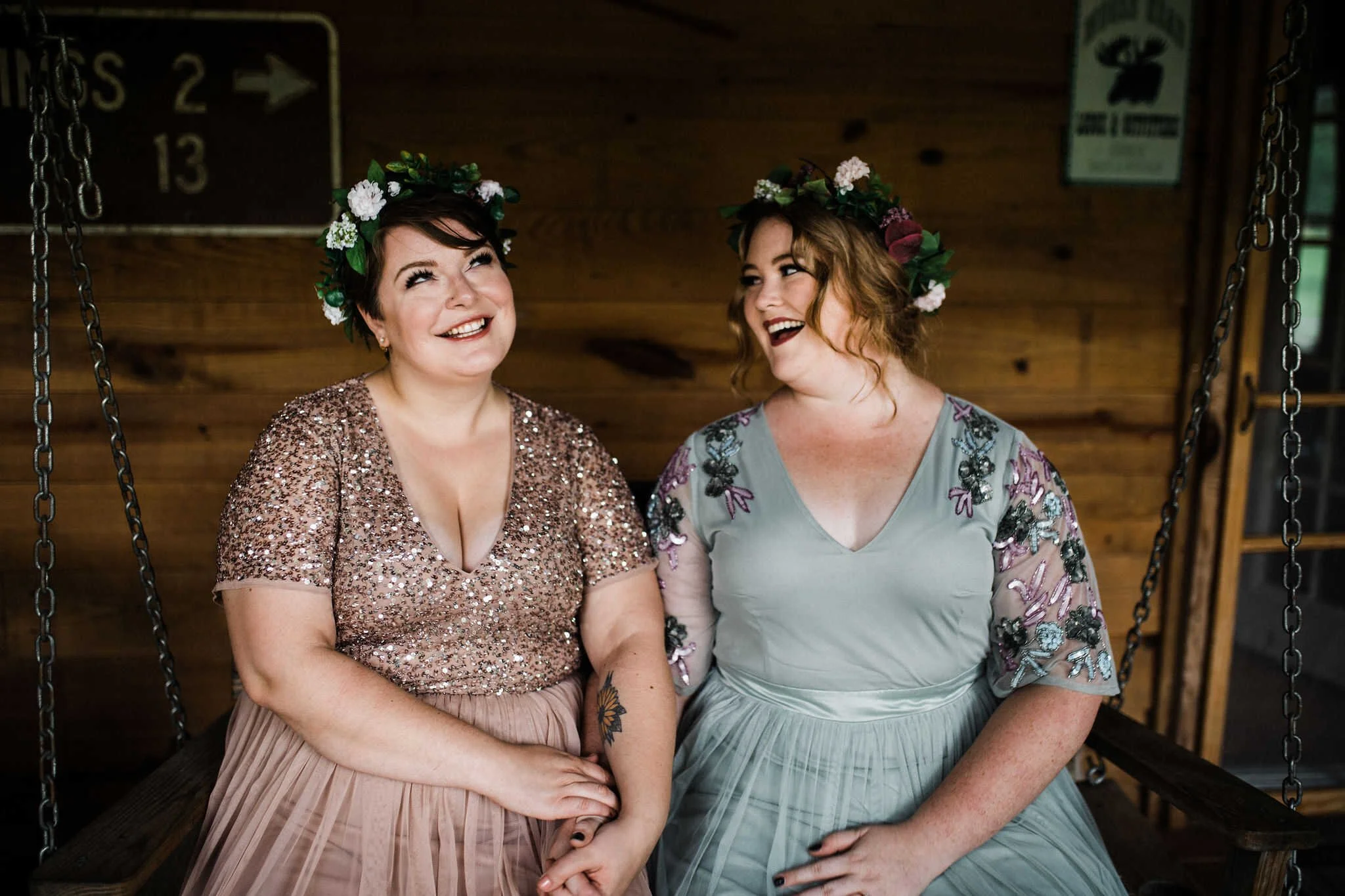 Two brides sit together and smile