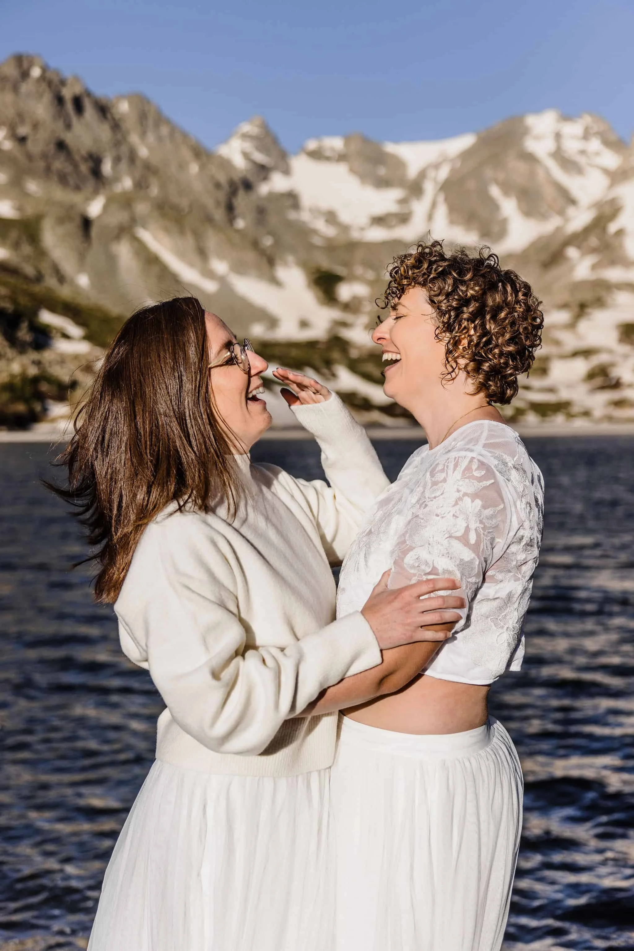 Two brides laugh together