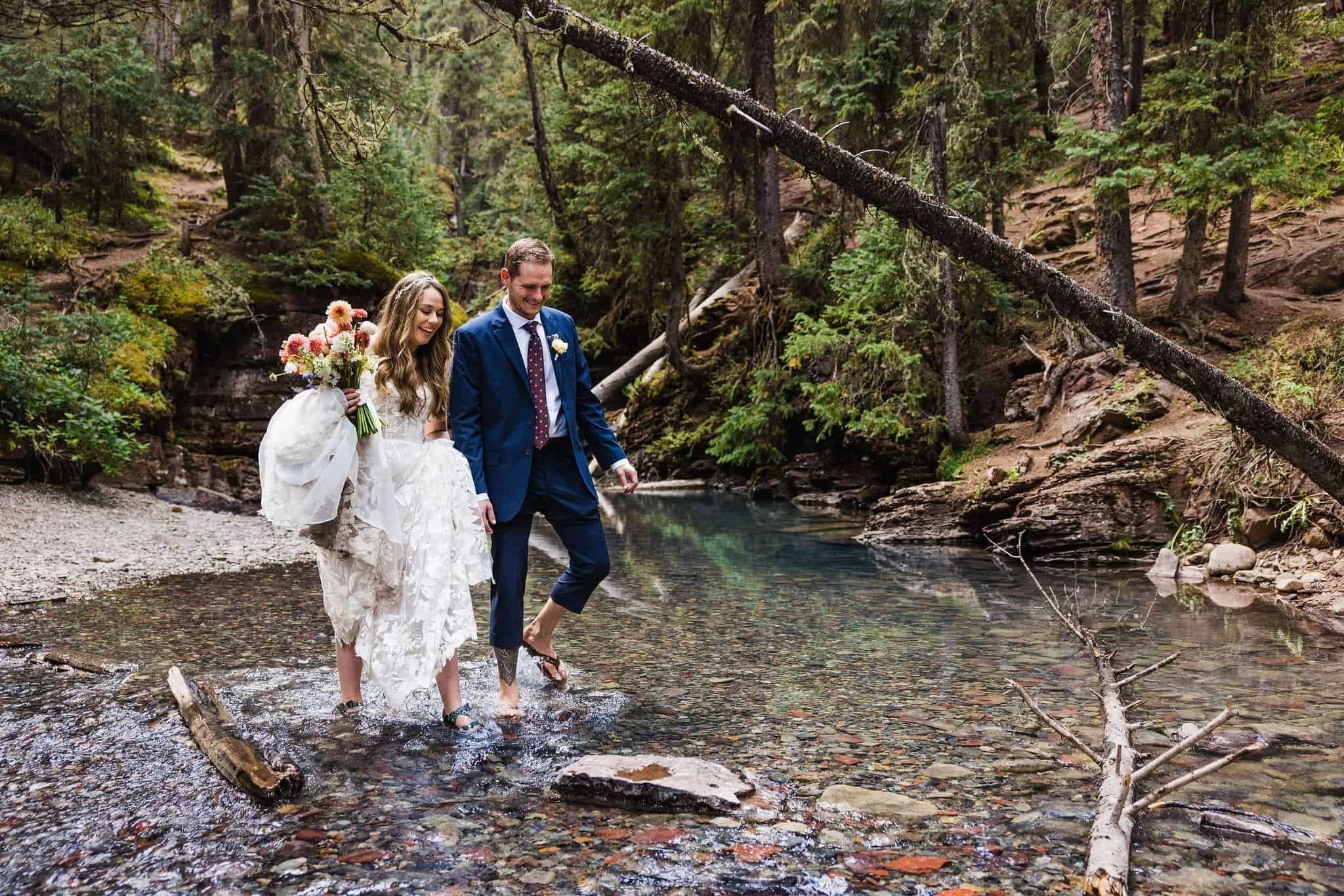 A couple hikes across a shallow river