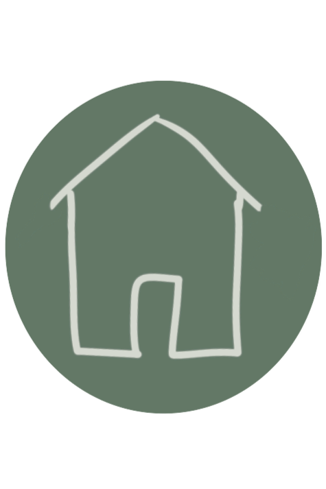 Simple white line drawing of a house with a pitched roof and a door on a green oval background.