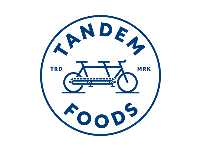 Blue and white Tandem Foods emblem.