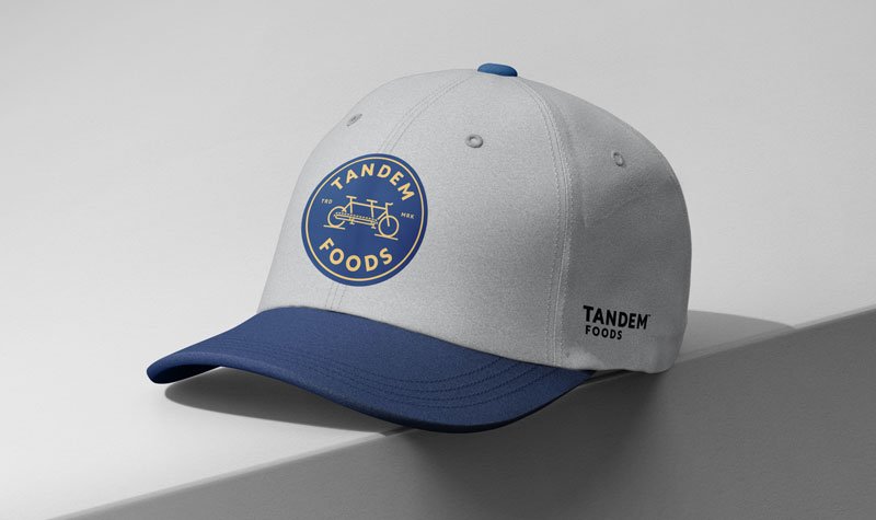 Light gray and blue cap with blue and gold Tandem emblem.